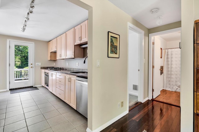 17 Claus Way, Marstons Mills, MA 02648 - kitchen with a sink, appliances with stainless steel finishes, rail lighting, baseboards, and dark countertops