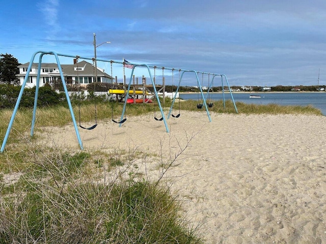 view of jungle gym featuring a water view