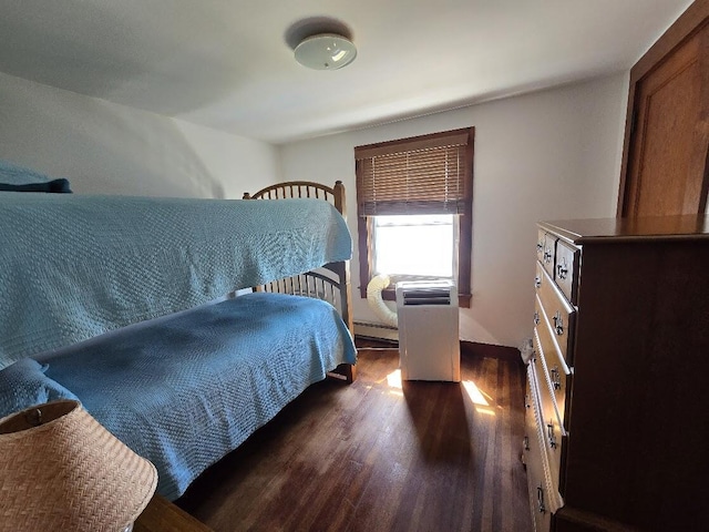 bedroom featuring a baseboard radiator and dark hardwood / wood-style flooring