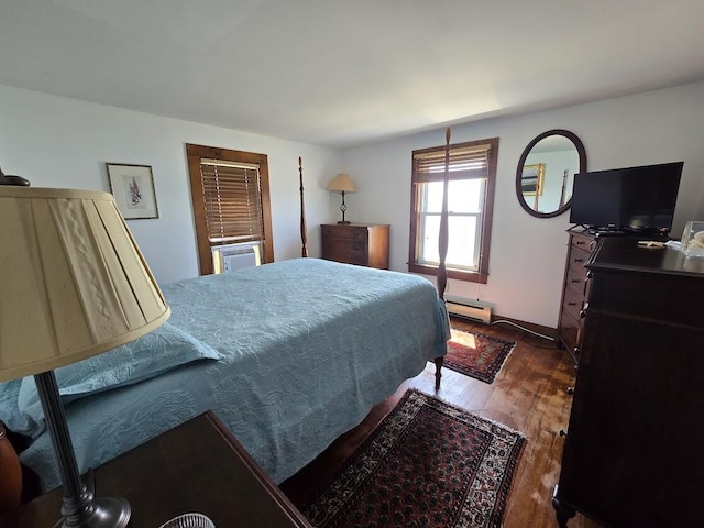 bedroom with dark wood-type flooring and a baseboard radiator