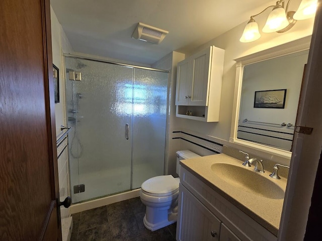 bathroom featuring toilet, a shower with door, and vanity