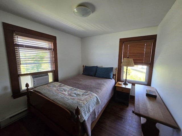 bedroom with a baseboard radiator and dark hardwood / wood-style flooring