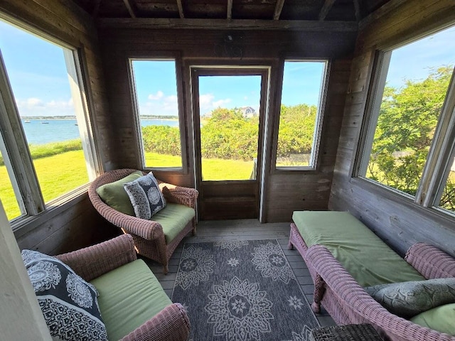 sunroom / solarium with a water view and plenty of natural light