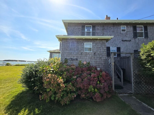 view of side of home with a lawn