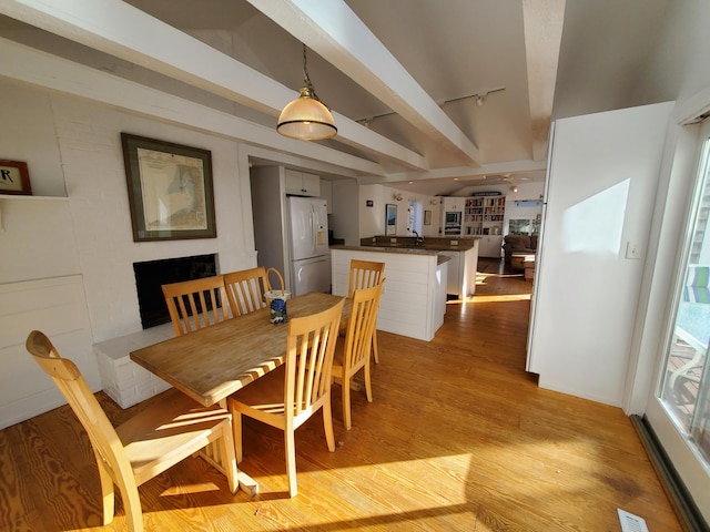 20 Spooner Rd, Eastham, MA 02642 - dining area with rail lighting, beam ceiling, and light wood-type flooring