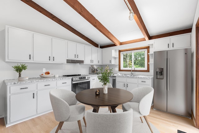 320 Coles Neck Rd, Wellfleet, MA 02667 - kitchen with appliances with stainless steel finishes, under cabinet range hood, open shelves, light wood-type flooring, and white cabinets