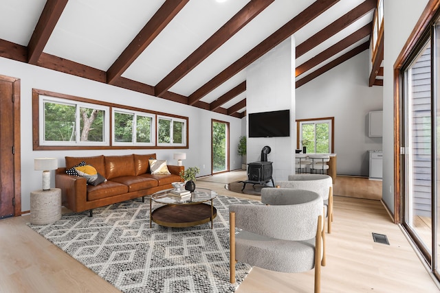 320 Coles Neck Rd, Wellfleet, MA 02667 - living area with a wood stove, beam ceiling, light wood-type flooring, and high vaulted ceiling