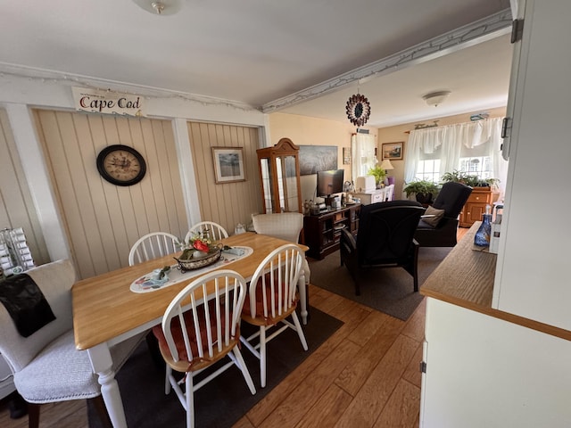 dining space with wood-type flooring