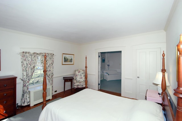 bedroom with dark hardwood / wood-style flooring, crown molding, radiator heating unit, and a closet