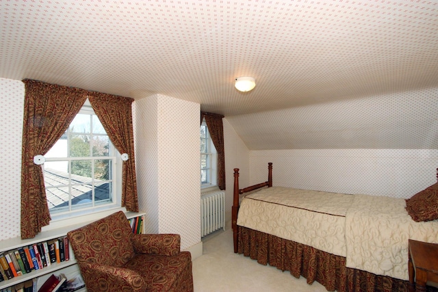 carpeted bedroom featuring radiator heating unit and vaulted ceiling