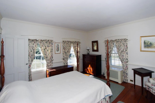 bedroom featuring crown molding, dark wood-type flooring, and radiator