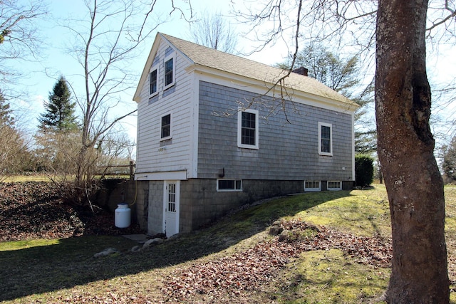 view of side of home featuring a yard