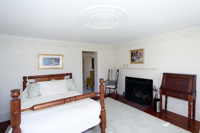 bedroom with dark hardwood / wood-style flooring