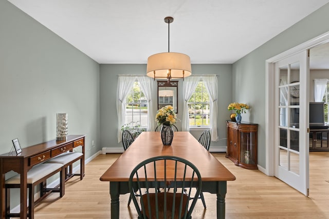 4 Canterbury Ln, Bourne, MA 02532 - dining area featuring light wood-style floors, a baseboard heating unit, and baseboards