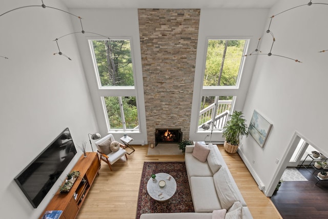 4 Canterbury Ln, Bourne, MA 02532 - living area featuring wood finished floors, a fireplace, and a high ceiling