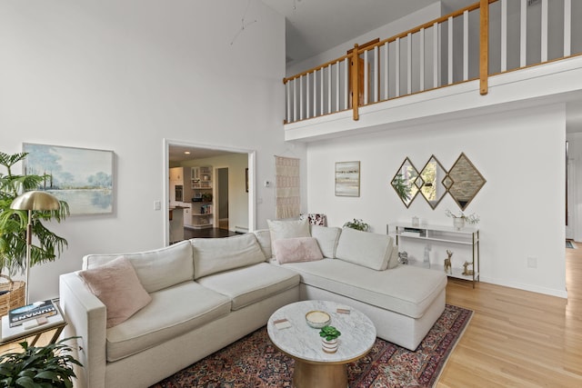 4 Canterbury Ln, Bourne, MA 02532 - living area featuring a high ceiling, wood finished floors, and baseboards