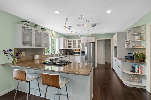4 Canterbury Ln, Bourne, MA 02532 - kitchen with open shelves, appliances with stainless steel finishes, a peninsula, a sink, and recessed lighting