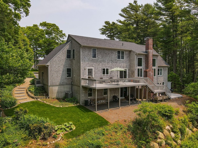 4 Canterbury Ln, Bourne, MA 02532 - back of house featuring stairs, a chimney, a patio, a wooden deck, and a yard