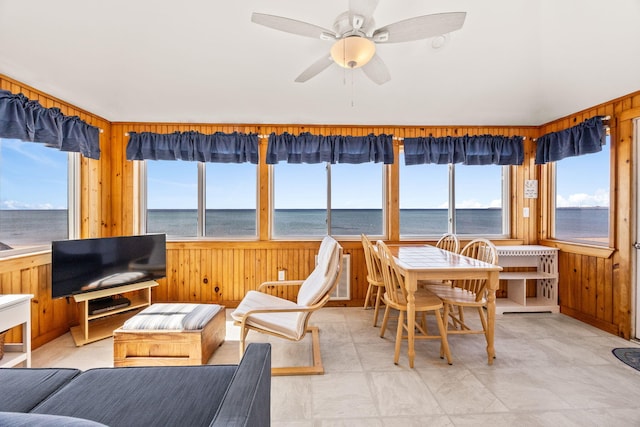 sunroom / solarium featuring wood walls