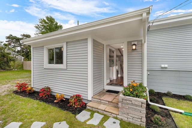 entrance to property with a lawn