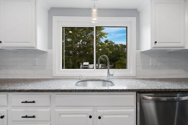 kitchen featuring sink, decorative light fixtures, white cabinetry, and stainless steel dishwasher