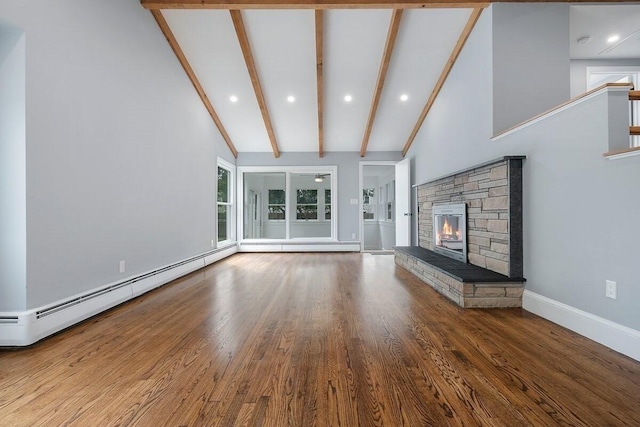 unfurnished living room with a baseboard heating unit, beamed ceiling, a stone fireplace, high vaulted ceiling, and hardwood / wood-style flooring