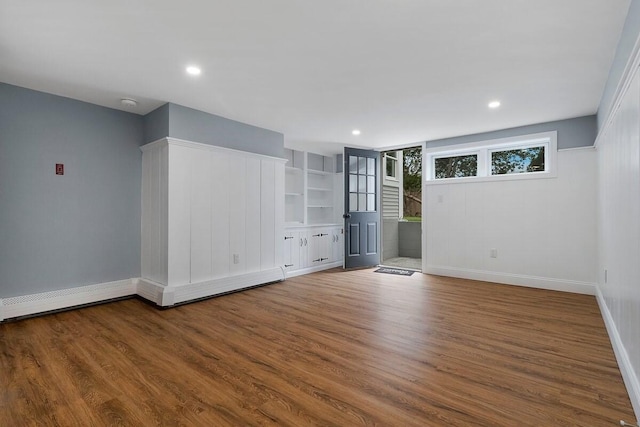 spare room featuring hardwood / wood-style flooring and a baseboard heating unit