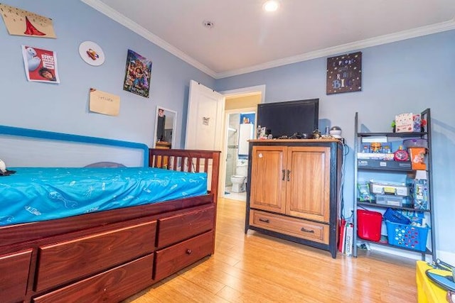 bedroom featuring crown molding and light wood-type flooring