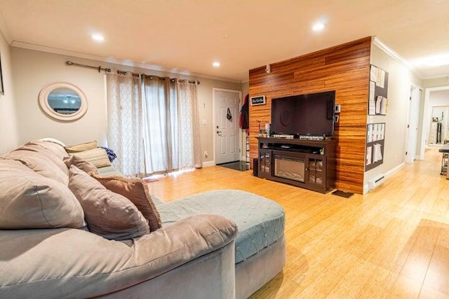 living room featuring ornamental molding and light wood-type flooring