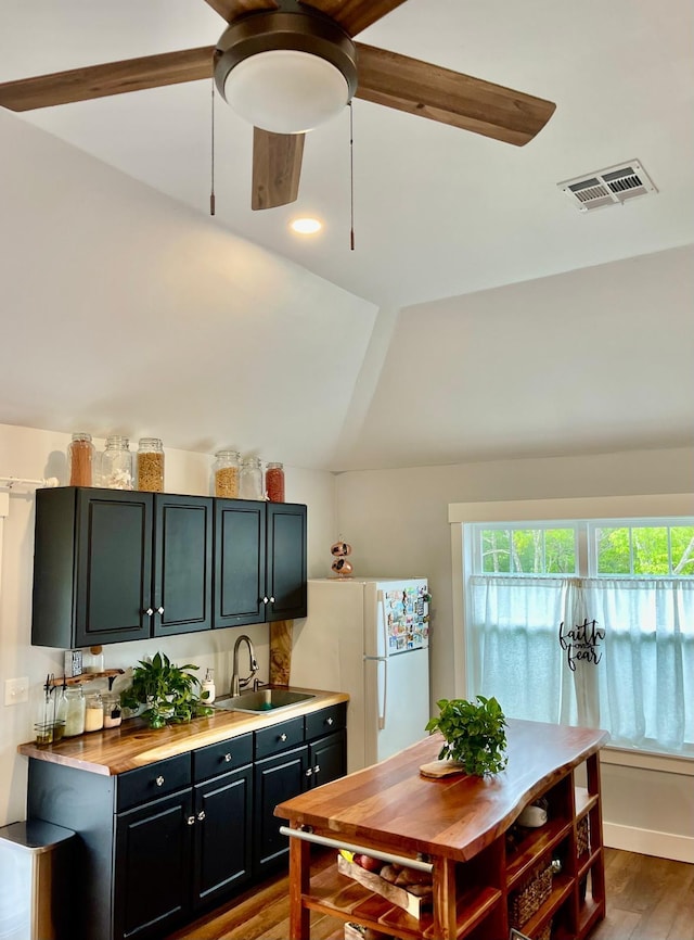 160 Ashumet Rd, East Falmouth, MA 02536 - kitchen with freestanding refrigerator, lofted ceiling, dark cabinetry, wood finished floors, and ceiling fan