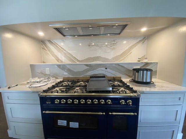 160 Ashumet Rd, East Falmouth, MA 02536 - kitchen featuring range with two ovens, ventilation hood, and light stone countertops