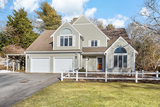 view of front of property with aphalt driveway, a garage, fence, roof with shingles, and a front lawn