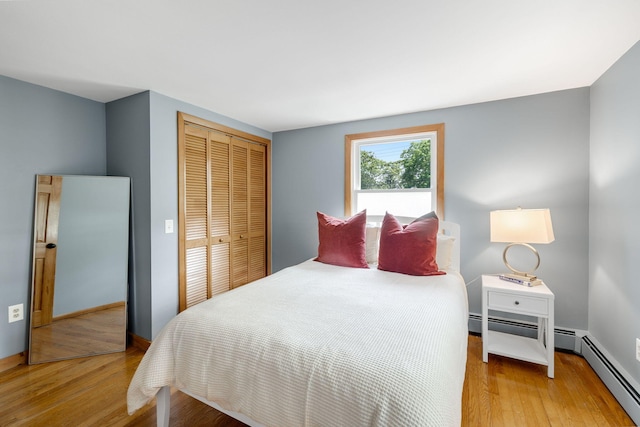 6 Paddock Dr, Harwich, MA 02645 - bedroom with baseboard heating, light wood-style flooring, and a closet