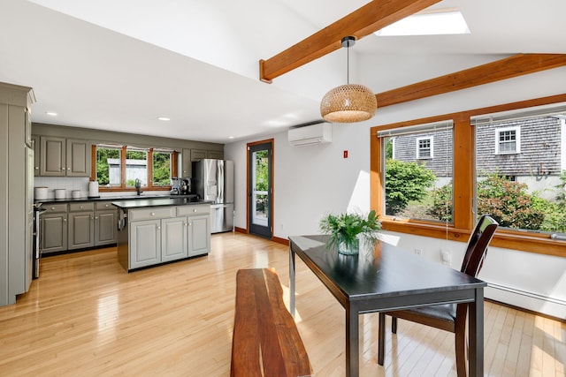 6 Paddock Dr, Harwich, MA 02645 - dining room with an AC wall unit, a baseboard radiator, light wood finished floors, recessed lighting, and a skylight