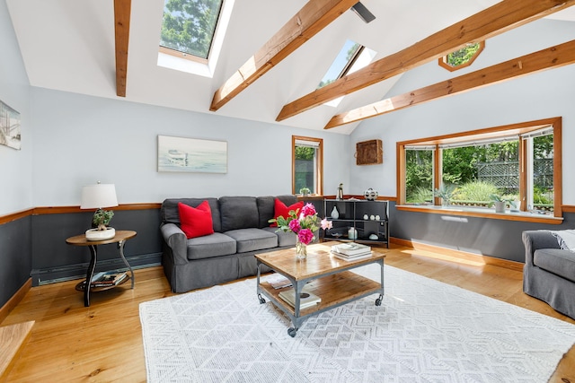 6 Paddock Dr, Harwich, MA 02645 - living area featuring a baseboard heating unit, wood finished floors, beam ceiling, a skylight, and high vaulted ceiling