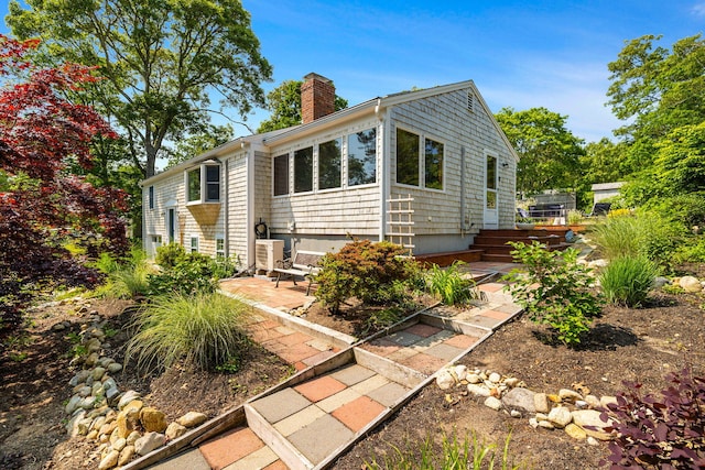 6 Paddock Dr, Harwich, MA 02645 - view of front of property with a chimney and a patio