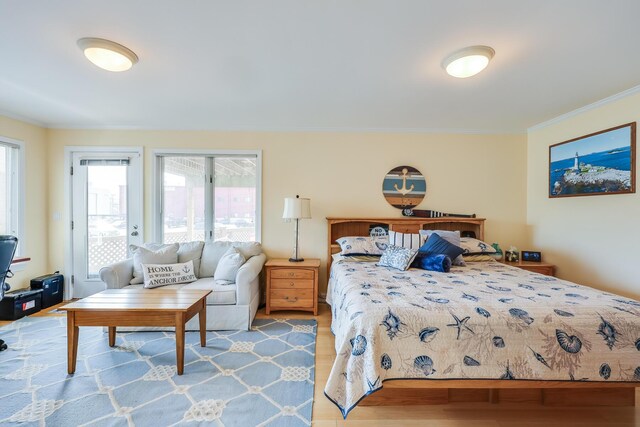 bedroom featuring wood-type flooring and crown molding