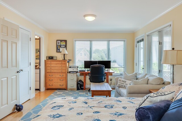 office space with crown molding and light hardwood / wood-style flooring