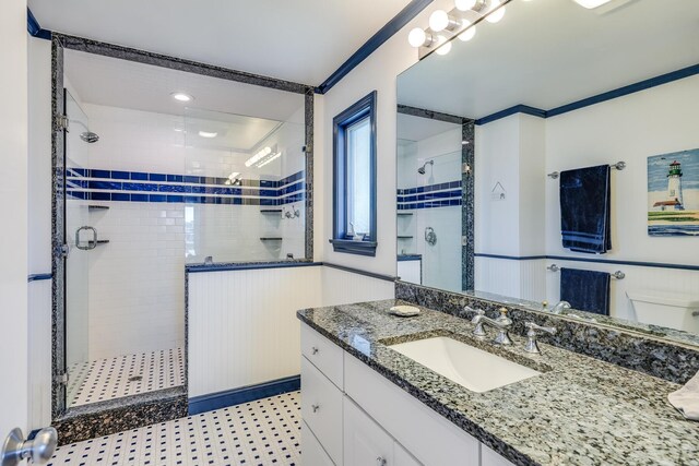 bathroom featuring vanity, ornamental molding, and an enclosed shower