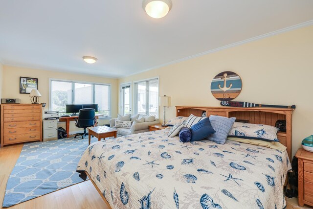 bedroom with crown molding and light wood-type flooring