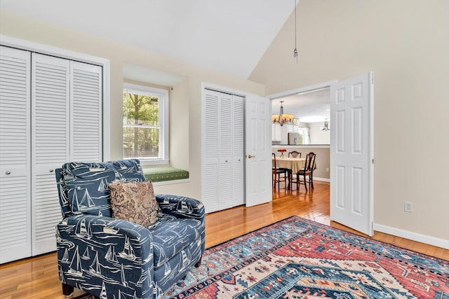 17 Greenway Cir, Sandwich, MA 02563 - sitting room featuring a chandelier, lofted ceiling, wood finished floors, and baseboards