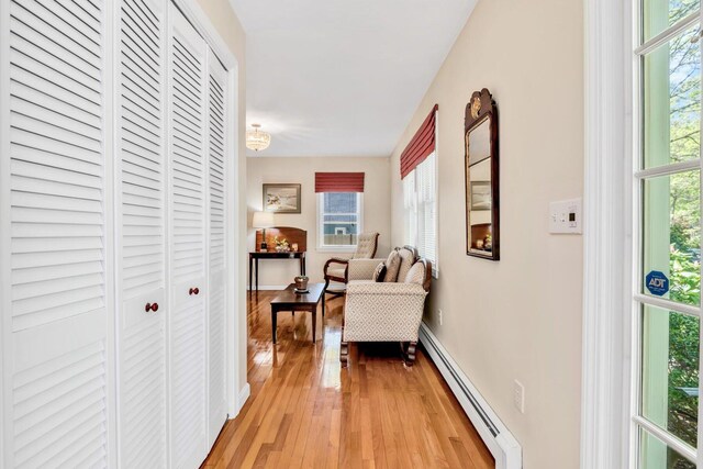 17 Greenway Cir, Sandwich, MA 02563 - corridor featuring a baseboard radiator, plenty of natural light, light wood finished floors, and baseboards