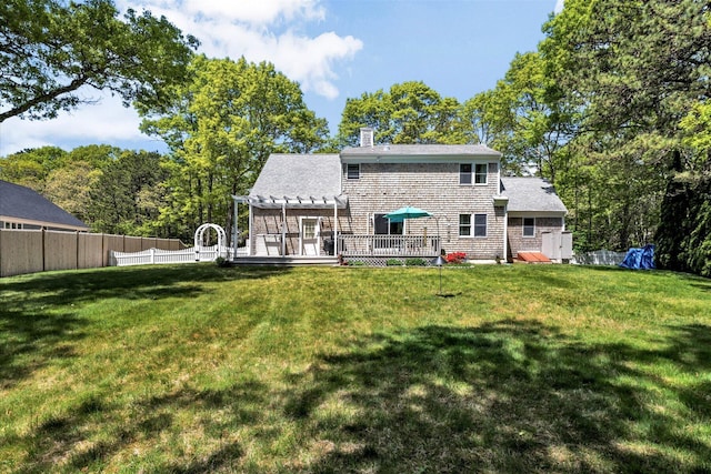 17 Greenway Cir, Sandwich, MA 02563 - back of property featuring a pergola, a deck, and a chimney