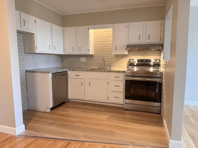 kitchen featuring appliances with stainless steel finishes, sink, white cabinets, tasteful backsplash, and light hardwood / wood-style floors