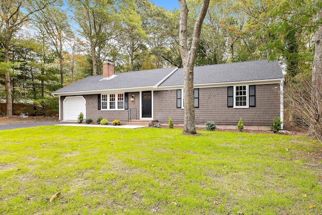 ranch-style house featuring a garage and a front lawn