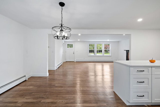 unfurnished dining area featuring a baseboard radiator, a chandelier, and dark hardwood / wood-style floors