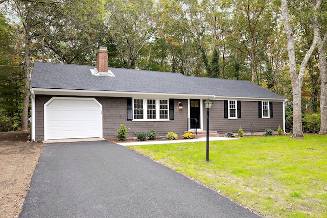 single story home featuring a garage and a front lawn