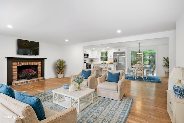 living room with light hardwood / wood-style flooring and a fireplace