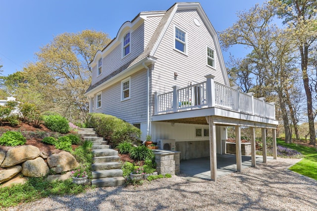 116 Happy Valley Rd, Chatham, MA 02633 - view of property exterior featuring a wooden deck, a patio, stairway, and a gambrel roof