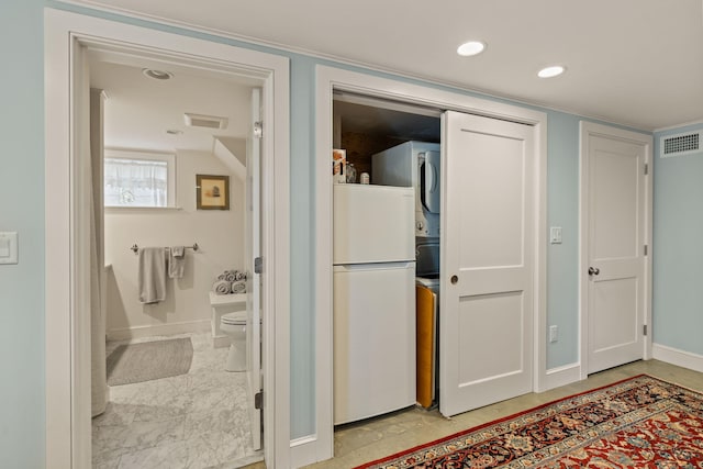 116 Happy Valley Rd, Chatham, MA 02633 - bathroom featuring estacked washer and dryer, baseboards, and toilet